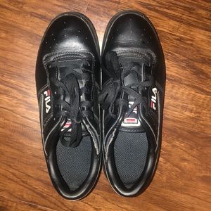 These are some black,red and white Fila shoes